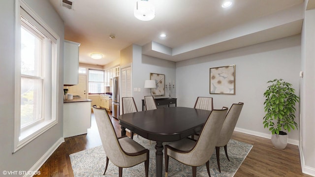 dining space with dark wood-type flooring, recessed lighting, visible vents, and baseboards