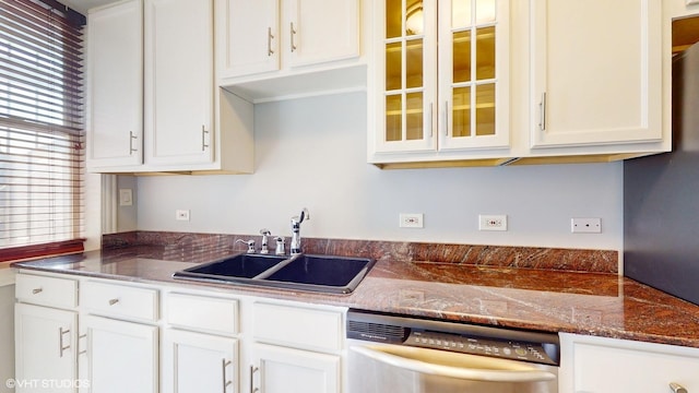 kitchen with a sink, glass insert cabinets, white cabinets, and stainless steel dishwasher