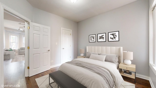 bedroom featuring dark wood-style flooring and baseboards