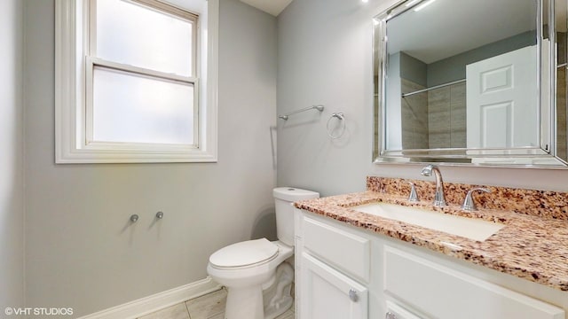 bathroom with baseboards, toilet, tile patterned floors, walk in shower, and vanity