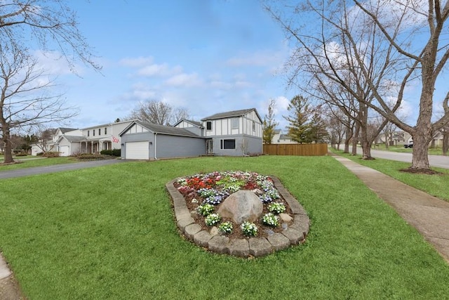 exterior space featuring an attached garage, fence, and aphalt driveway