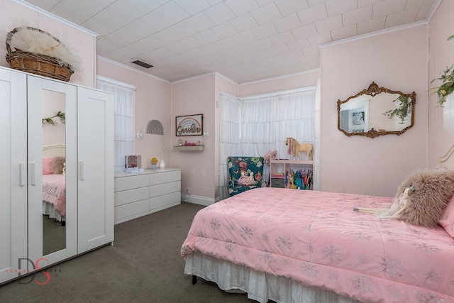 bedroom with visible vents, dark colored carpet, and crown molding