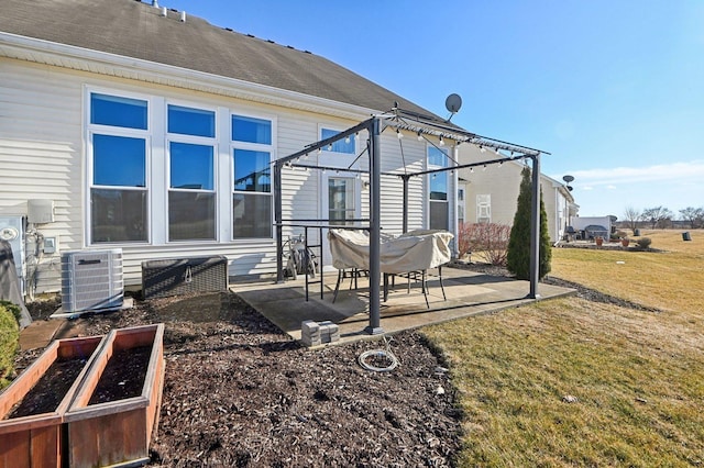 rear view of property featuring a yard, roof with shingles, a patio area, and central air condition unit