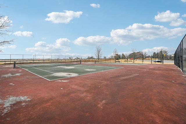 view of tennis court with fence