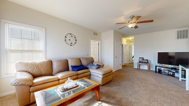 living room with visible vents, carpet floors, baseboards, and ceiling fan