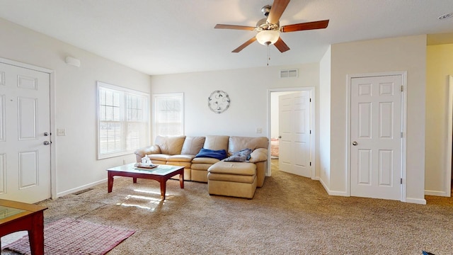 living room featuring visible vents, baseboards, carpet, and a ceiling fan