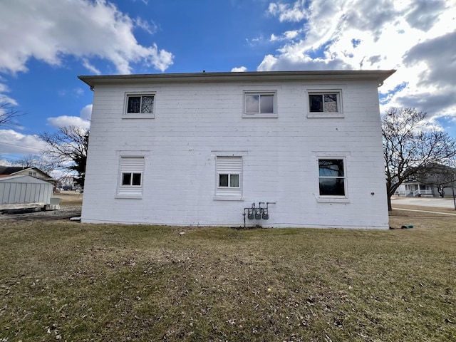 rear view of property with a yard