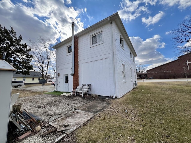 rear view of house featuring a lawn