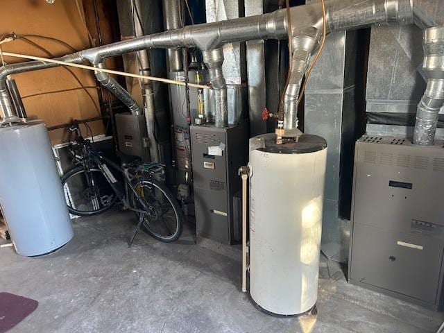 utility room featuring gas water heater and heating unit