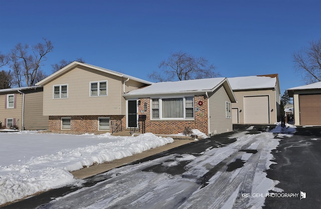 tri-level home featuring brick siding and an attached garage