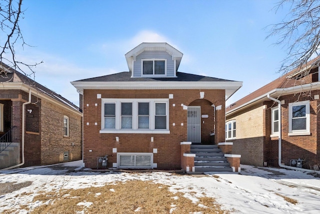 view of front of property with entry steps and brick siding