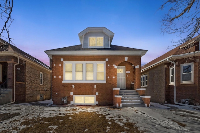 view of front facade featuring entry steps and brick siding