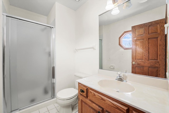 bathroom featuring a stall shower, tile patterned flooring, vanity, and toilet