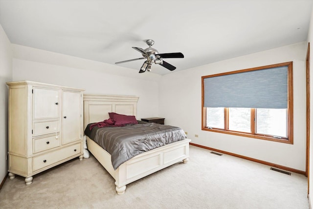 bedroom with baseboards, visible vents, a ceiling fan, and light colored carpet