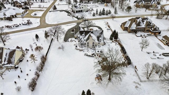 snowy aerial view with a residential view