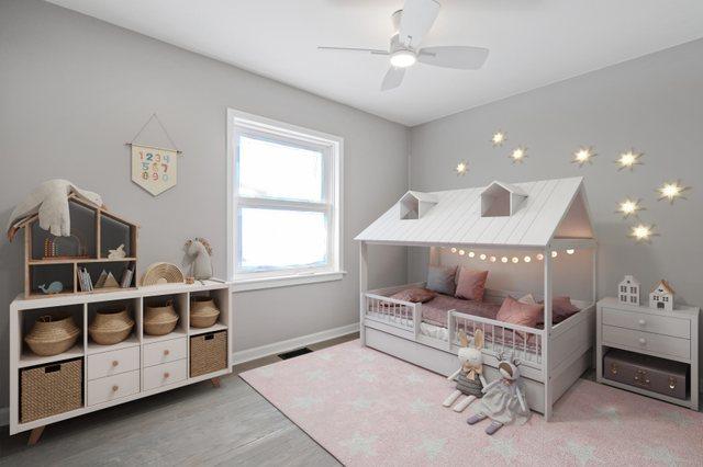 bedroom featuring visible vents, baseboards, and wood finished floors