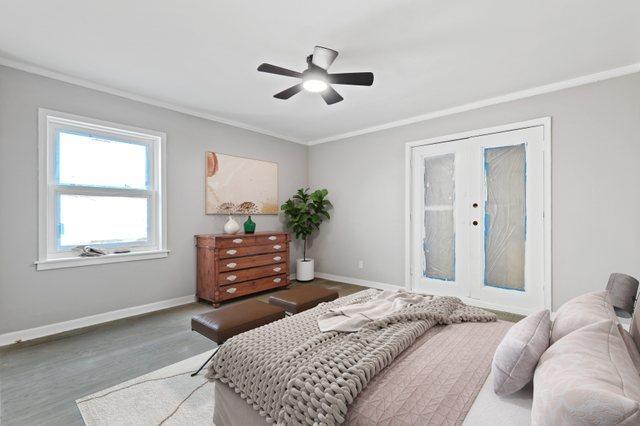 bedroom with ceiling fan, wood finished floors, baseboards, french doors, and crown molding