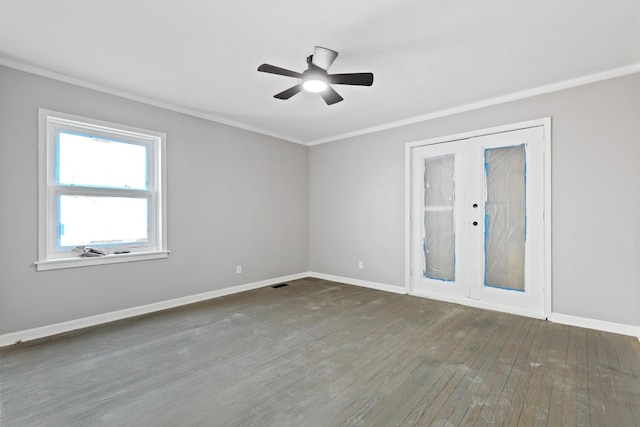 spare room featuring visible vents, baseboards, wood finished floors, crown molding, and french doors