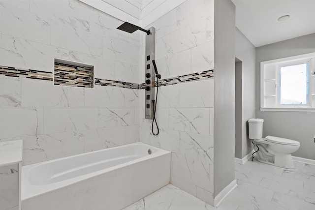 full bathroom with toilet, marble finish floor, baseboards, and bathing tub / shower combination