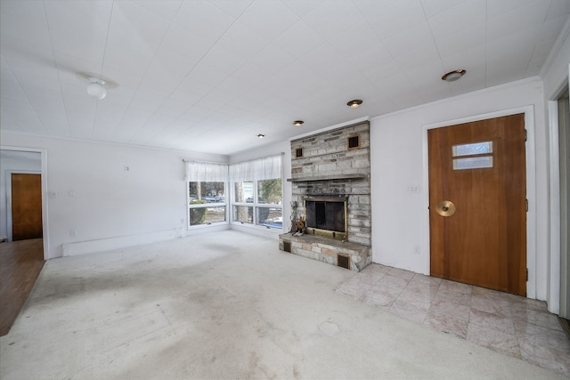 unfurnished living room with light colored carpet, crown molding, and a stone fireplace