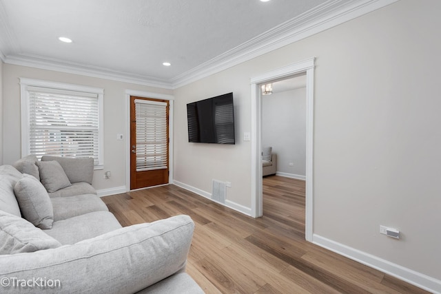 living area with recessed lighting, wood finished floors, visible vents, baseboards, and ornamental molding