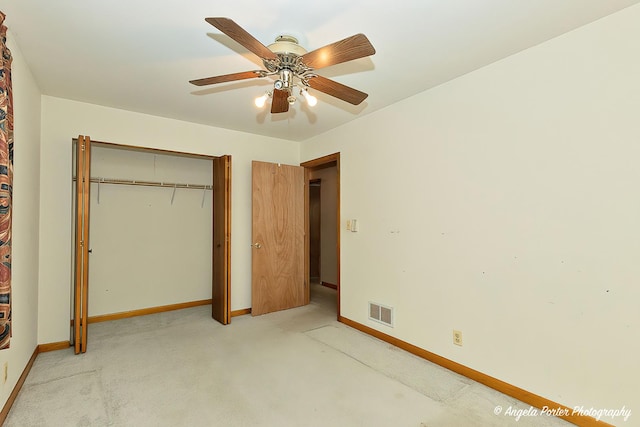 unfurnished bedroom with visible vents, ceiling fan, light carpet, and baseboards