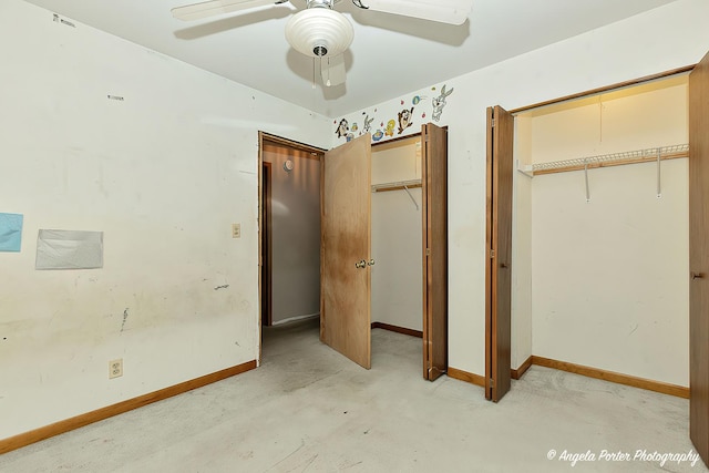 unfurnished bedroom featuring ceiling fan, baseboards, and two closets