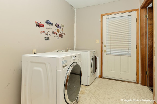 laundry area featuring laundry area, separate washer and dryer, and light floors