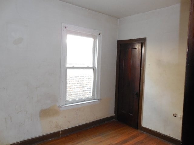 unfurnished room featuring dark wood finished floors