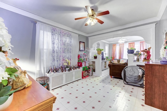 bedroom with arched walkways, light floors, ornamental molding, and a ceiling fan