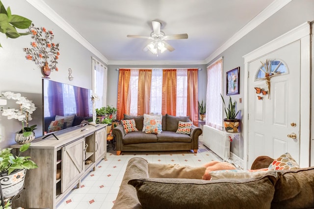 living room with radiator, a ceiling fan, and crown molding