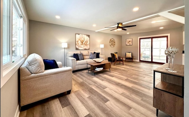 living room with recessed lighting, light wood-style flooring, and a healthy amount of sunlight