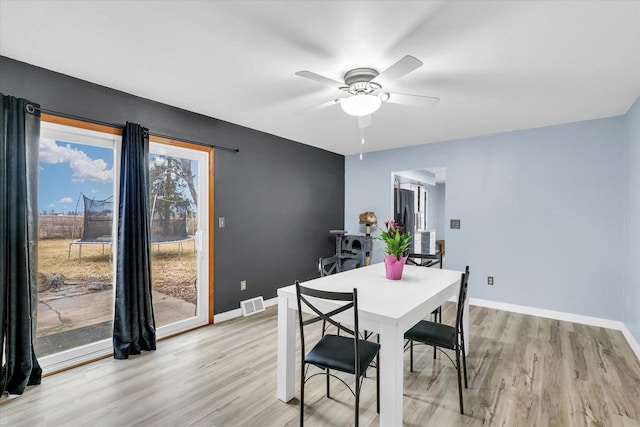 1695 Willowdale Dr, Saint Joseph, IL 61873 - dining room featuring a ceiling fan, baseboards, visible vents, and light wood finished floors