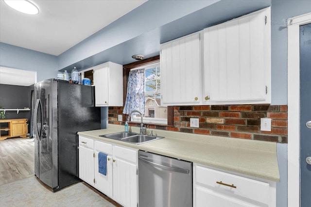 1695 Willowdale Dr, Saint Joseph, IL 61873 - kitchen with a sink, white cabinetry, light countertops, freestanding refrigerator, and dishwasher