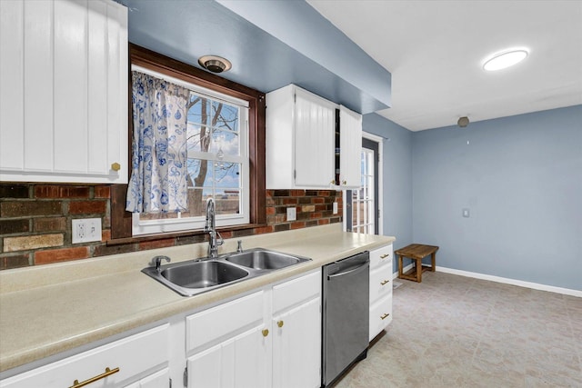 1695 Willowdale Dr, Saint Joseph, IL 61873 - kitchen featuring a wealth of natural light, baseboards, white cabinets, dishwasher, and a sink