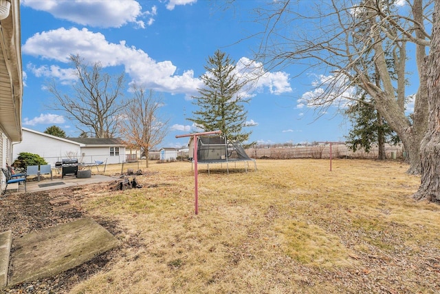 1695 Willowdale Dr, Saint Joseph, IL 61873 - view of yard featuring a patio, a trampoline, and a fenced backyard