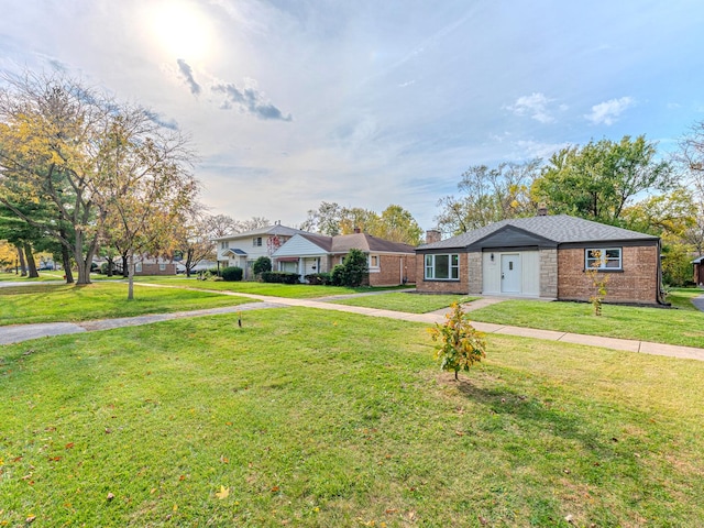 ranch-style house with a front lawn, a chimney, and brick siding