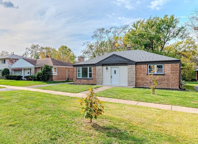 ranch-style house with brick siding, roof with shingles, a chimney, and a front yard