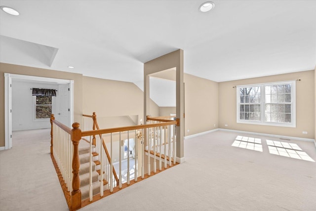 corridor featuring an upstairs landing, recessed lighting, baseboards, and light colored carpet