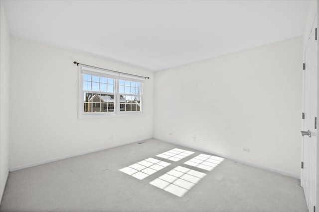 empty room with light carpet and baseboards