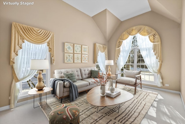 living area featuring light carpet, high vaulted ceiling, and baseboards