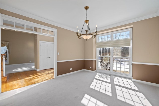 unfurnished dining area featuring carpet floors, a notable chandelier, and crown molding