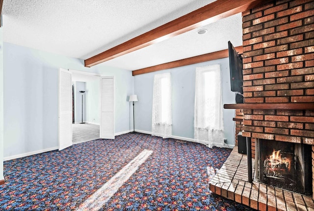 unfurnished living room featuring carpet floors, a brick fireplace, beam ceiling, and a textured ceiling