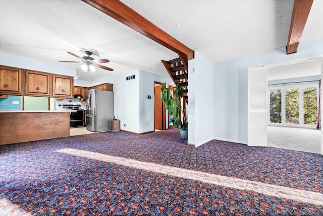 kitchen with range with electric cooktop, brown cabinetry, light colored carpet, freestanding refrigerator, and beam ceiling