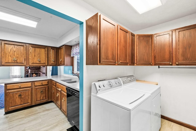 laundry area with a sink, baseboards, and separate washer and dryer