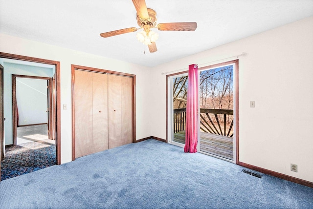 unfurnished bedroom featuring access to outside, carpet, visible vents, and baseboards