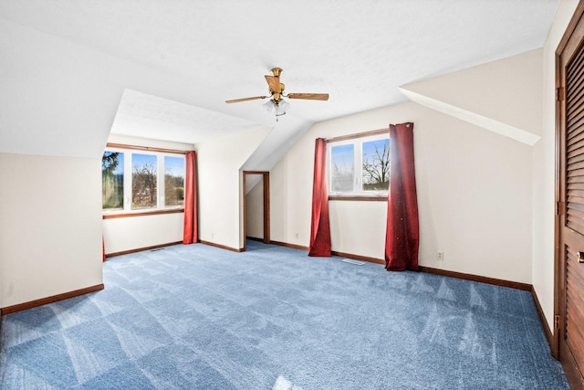 additional living space with lofted ceiling, ceiling fan, carpet, and baseboards