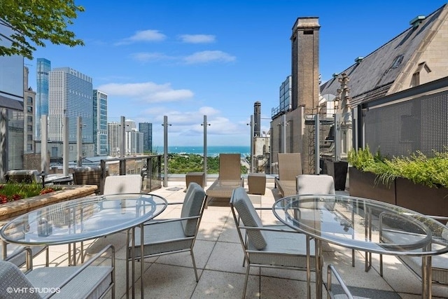 view of patio / terrace featuring a view of city and outdoor dining space