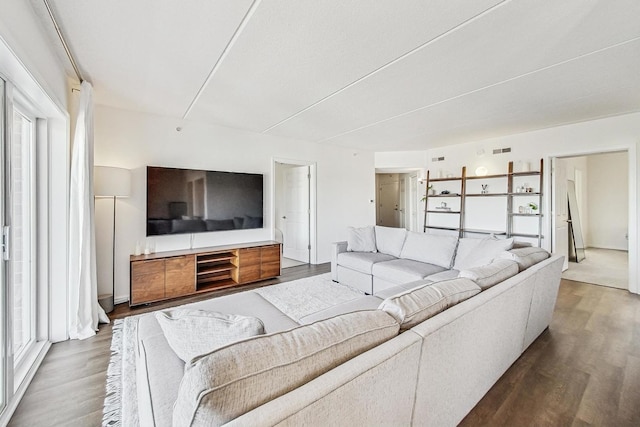 living room featuring visible vents and wood finished floors