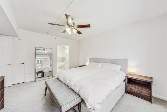 bedroom featuring ensuite bath, baseboards, ceiling fan, and light colored carpet